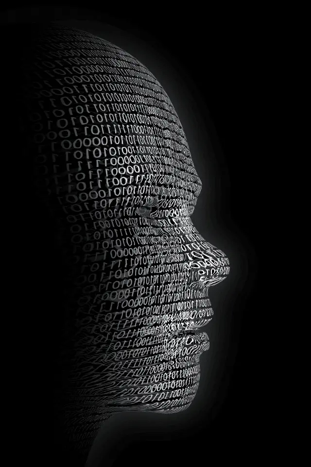 Profilo di un volto umanoide composto da codice binario, simbolo dell'intelligenza artificiale e della fusione tra uomo e tecnologia.