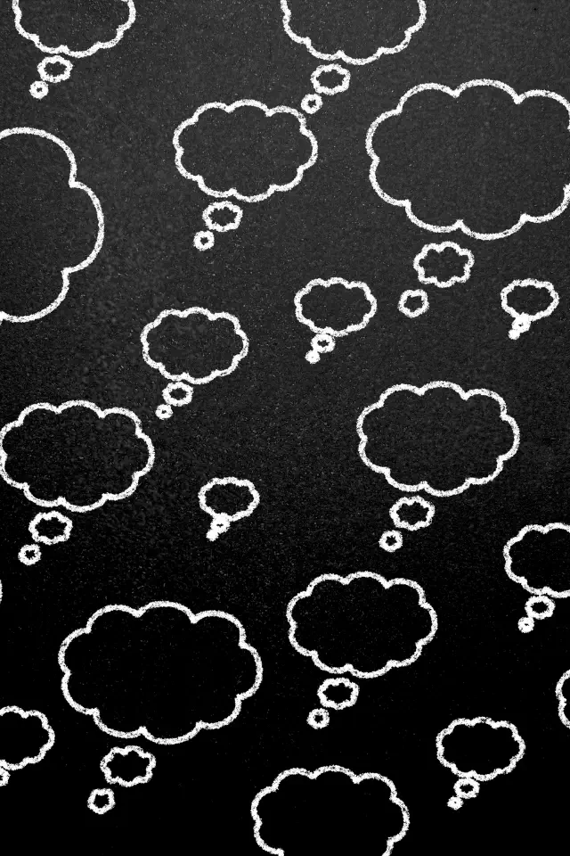 Disegno di nuvole di pensiero su sfondo nero, simbolo della natura dei pensieri e della loro influenza.